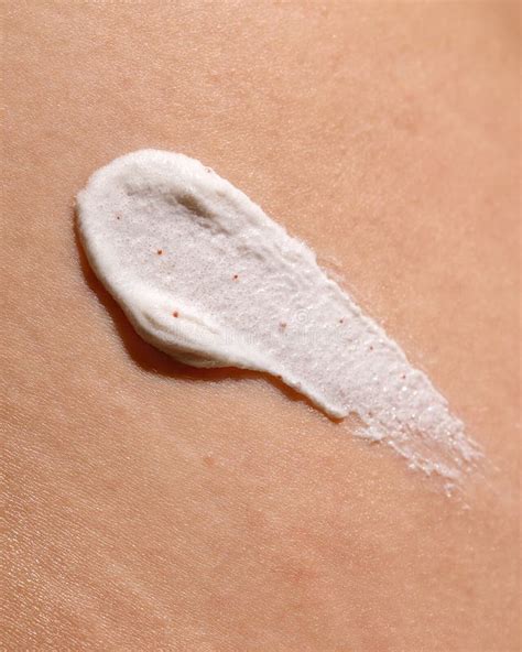 close-up image of a body scrub with visible exfoliating particles and moisturizing cream