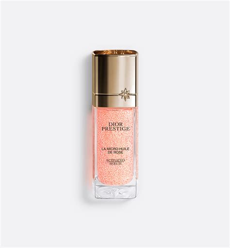Illustration of the Dior Prestige La Micro-Huile de Rose Activated Serum bottle with micro-pearls.