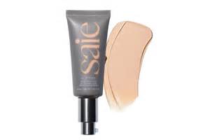 Close-up of a hand with Saie Slip Tint blended, showcasing its dewy finish and natural coverage.