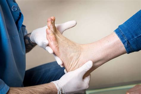 Close-up of a podiatrist examining a foot