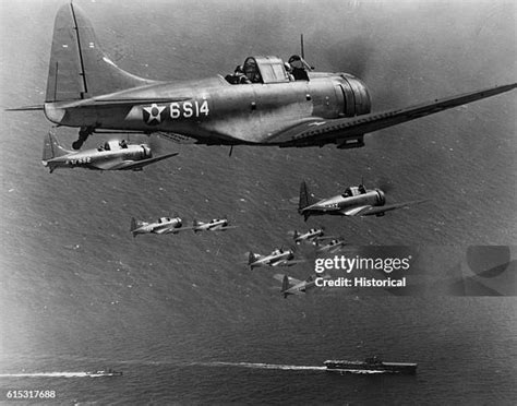Douglas SBD-3 Dauntless aircraft flying over USS Enterprise and USS Saratoga near Guadalcanal, December 1942.