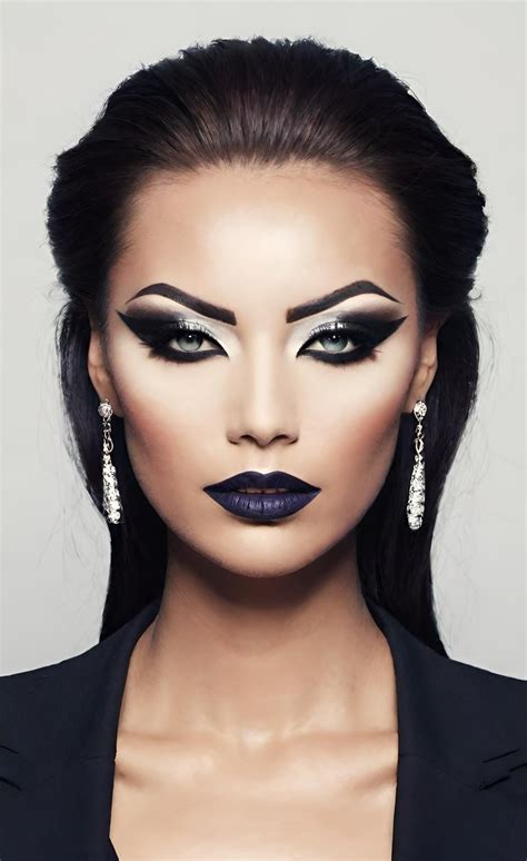 A dramatic smoky eye with bold eyeliner and false eyelashes, showcasing the intensity required for the skeleton makeup look.