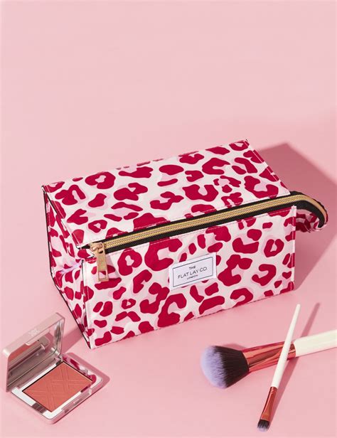 A visually appealing flat lay of the Flat Lay Co. XL Showcase makeup bag, showing products organized inside.