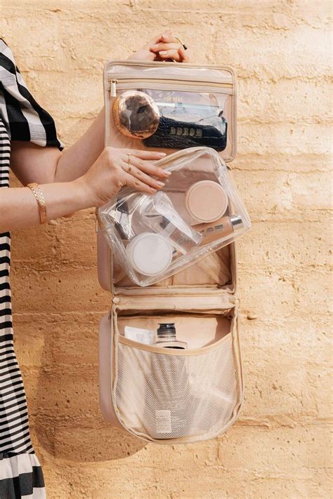 The Béis The Cosmetic Case shown open, displaying its organized compartments and mirror.