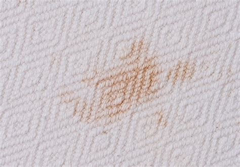 A close-up of a makeup stain on white fabric
