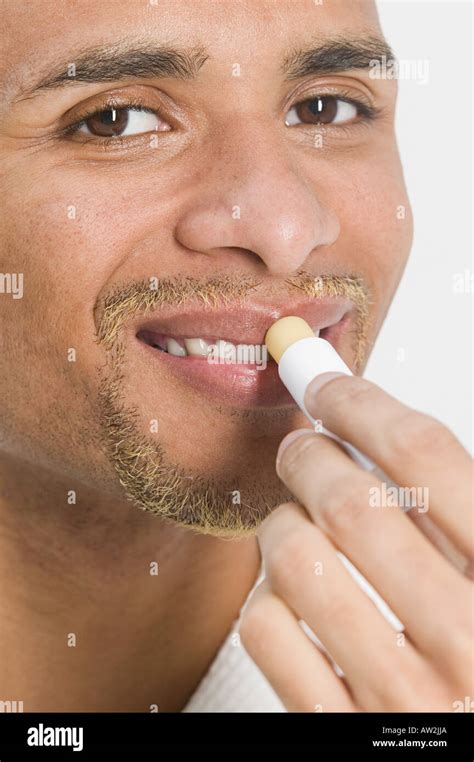 Man applying lip balm with SPF.