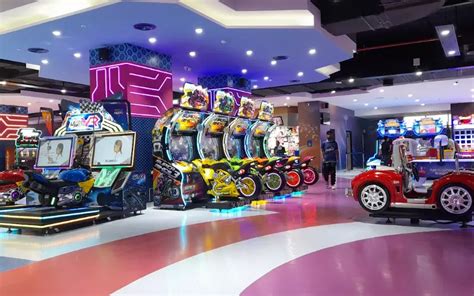 An image of children enjoying arcade games in the entertainment zone of Al Rashid Mall.