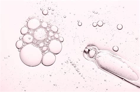 Close-up of a skincare product with retinol and a graphic illustrating collagen production.