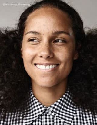 Alicia Keys in a natural, makeup-free look, highlighting her features.