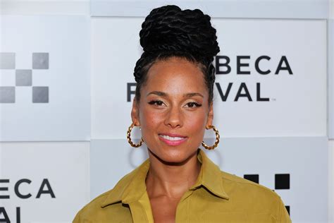 Alicia Keys attending a public event with a refined, natural makeup look.