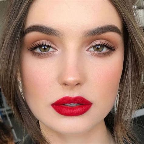 Close-up of a model with a classic bold red lipstick and subtle eye makeup.