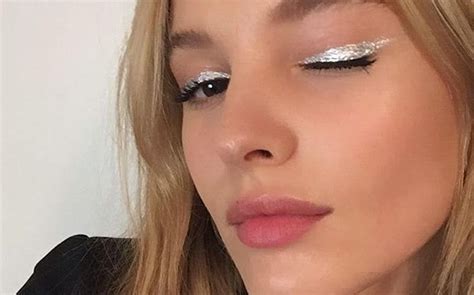 Close-up of an eye with shimmering silver glitter eyeshadow and a winged liner.