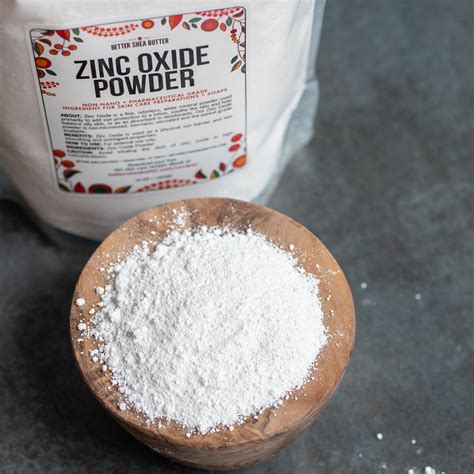 A close-up of non-nano zinc oxide powder in a small container, with a disclaimer about not inhaling the powder.
