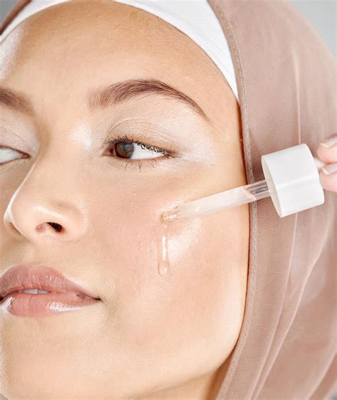 Woman applying anti-aging serum to her face