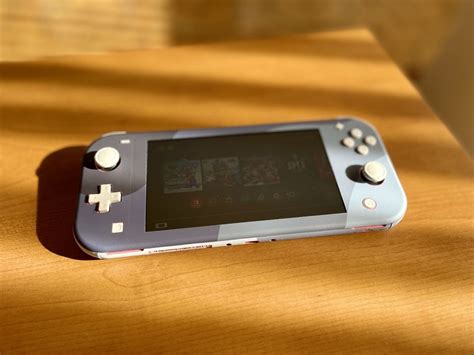 Close-up shot of a Nintendo Switch Lite with a dbrand skin, highlighting texture and fit