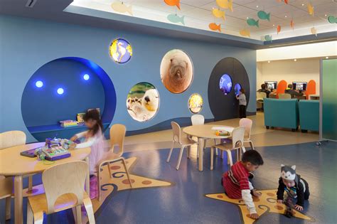 Interior of a modern, child-friendly pediatric dermatology clinic with a play area.