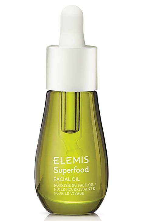 Dropper bottle of Elemis Superfood Face Oil with fresh ingredients like broccoli and flaxseed