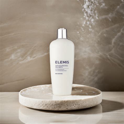 Bottle of Elemis Skin Nourishing Milk Bath next to a luxurious bathtub
