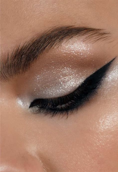 Close-up of an eye with neutral cream eyeshadow applied from lashline to crease and smudged on the lower lashline.