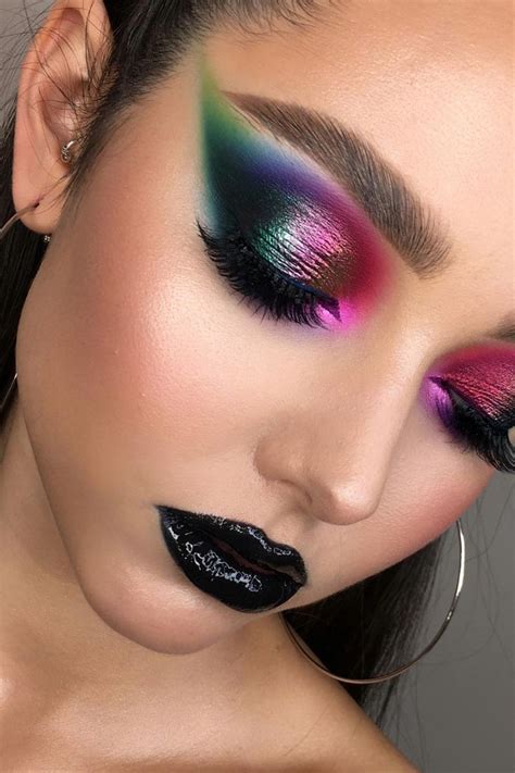A dramatic eye makeup look featuring bold colors and a liberal application of rhinestones across the eyelid and brow bone.