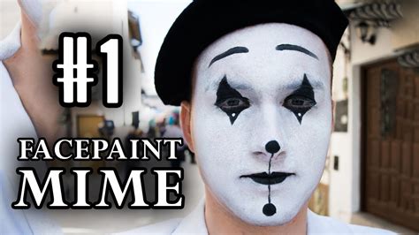 Close-up of a face being filled with white mime paint