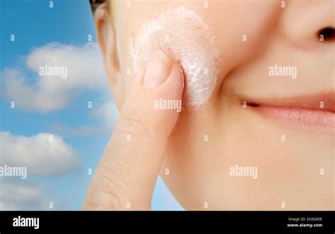 close-up of a face with moisturizer being applied