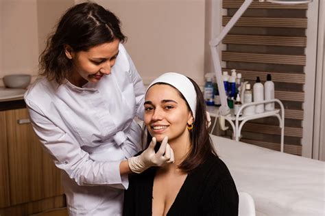 Aesthetician consulting with a client about lip fillers.