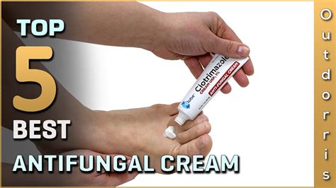 A person's hands applying antifungal cream to the groin area.