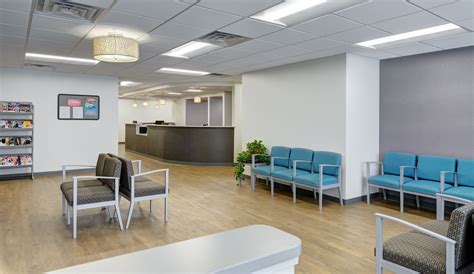Illustration of a modern, clean dermatology clinic waiting room with friendly reception staff.