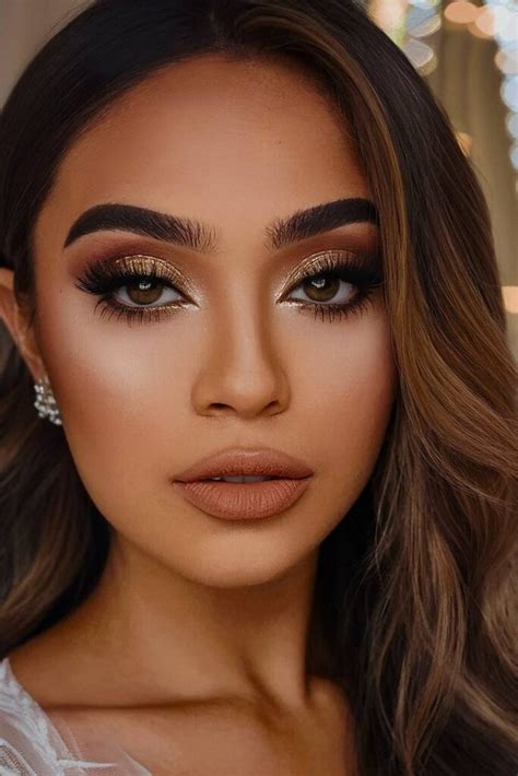 A bride with a soft, blended smoky eye in earthy tones and a nude lip.