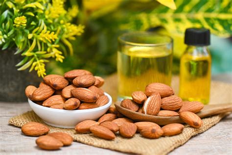 Close-up photo of almonds and a bottle of almond oil, with visuals representing smooth and shiny hair.