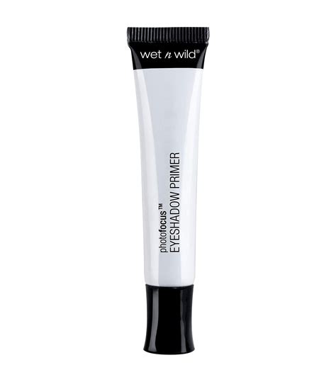 A close-up shot of the Wet n Wild PhotoFocus Eyeshadow Primer tube and its creamy texture on a fingertip.