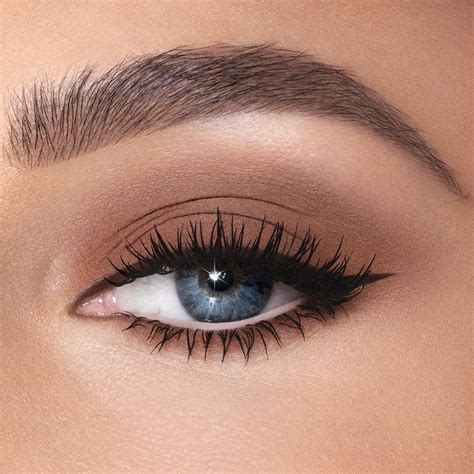 A close-up of eyes with neutral eyeshadow, mascara, and a subtle wash of bronze cream shadow.