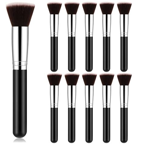 A flat lay of makeup brushes, contour palette, highlighter, foundation, and primer.