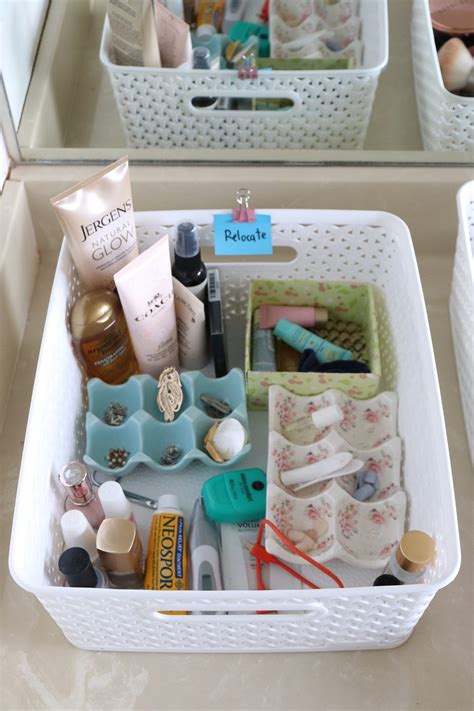 Someone cleaning out a makeup drawer with disinfecting wipes.