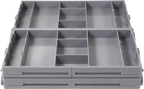 A close-up of a drawer organizer with small compartments, neatly holding individual lipsticks.