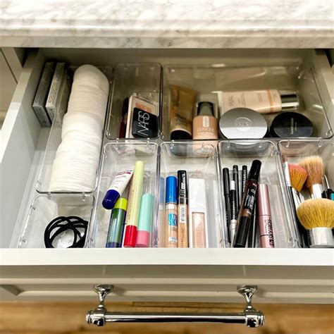 A neatly organized makeup drawer with various compartments, showing a clear system for product placement.