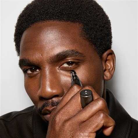 Diverse group of men applying makeup with different tools and products