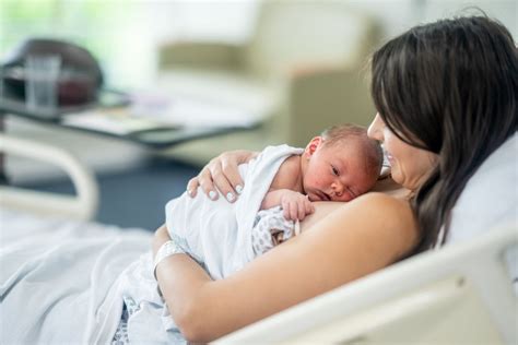 Infant being held skin-to-skin on parent's chest