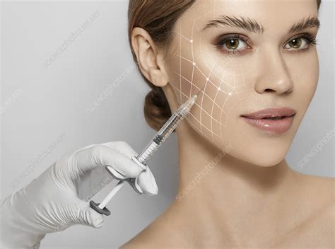 Photo of a medical professional demonstrating a cosmetic injection technique on a mannequin.