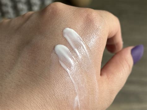 Close-up texture shot of the sunscreen, showing its lotion-like consistency