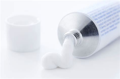 close-up photo of various topical creams and ointments in their packaging