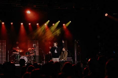 Sammy Rash performing live on stage, engaging with the audience.