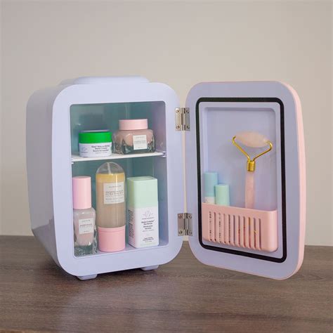 A collection of colorful skincare products neatly arranged inside a mini skincare fridge.