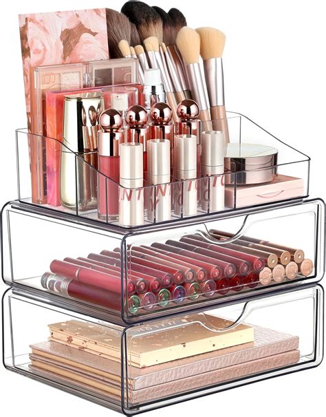 A multi-tiered acrylic makeup organizer with various brushes, lipsticks, and palettes.