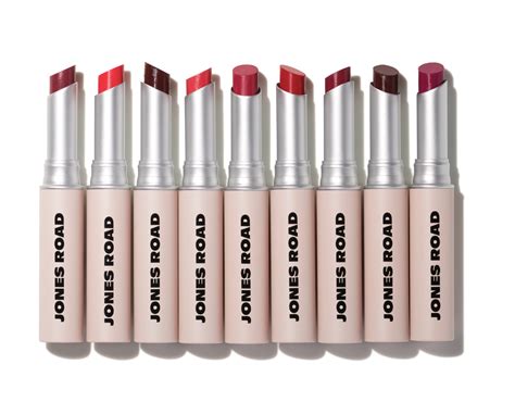 A swatch of various Jones Road Lip Tint shades on different skin tones, demonstrating their sheer to buildable coverage.