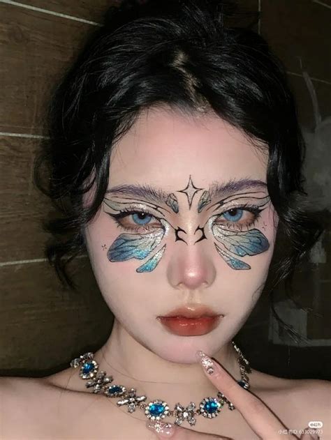 Fairy makeup with intricate butterfly detailing on the eyelids.