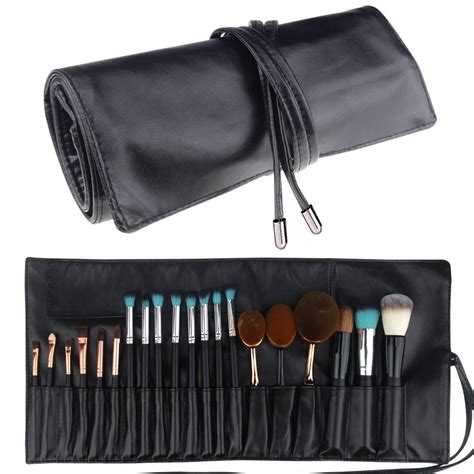 A leather brush roll laid out flat, showing individual slots for various makeup brushes.