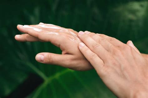 Close-up photograph showing smooth, hydrated hands after application of the cream.