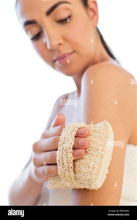 close-up image of a person using an exfoliating mitt on their arm